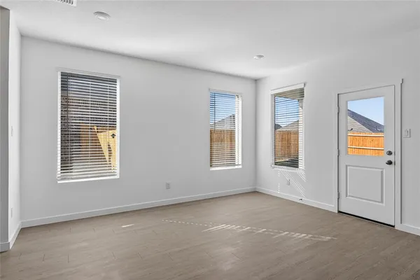 a view of an empty room with a kitchen