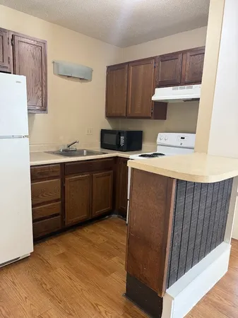 a kitchen with a sink a stove and refrigerator