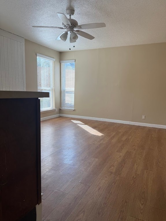 1000 West 26th Street, Unit 104 Austin, TX 78705 - Photo 4 of 8 an empty room with wooden floor and windows