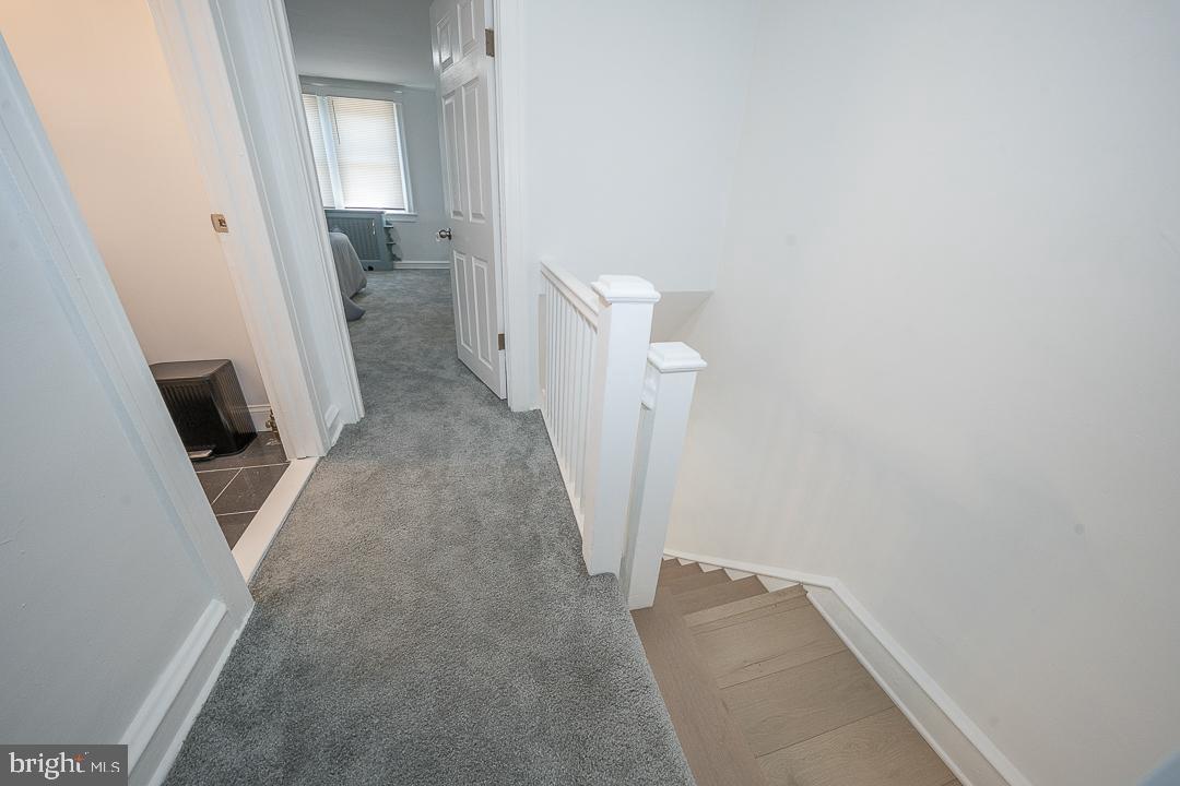 426 Hampden Road Upper Darby, PA 19082 - Photo 16 of 31 a view of a hallway with wooden floor and a bathroom