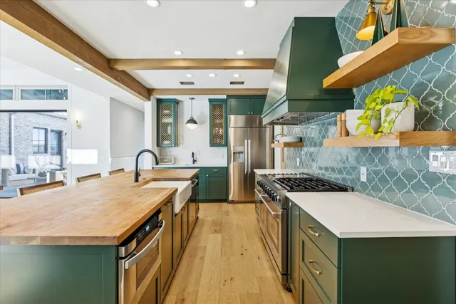 a kitchen with stainless steel appliances granite countertop a sink and a stove