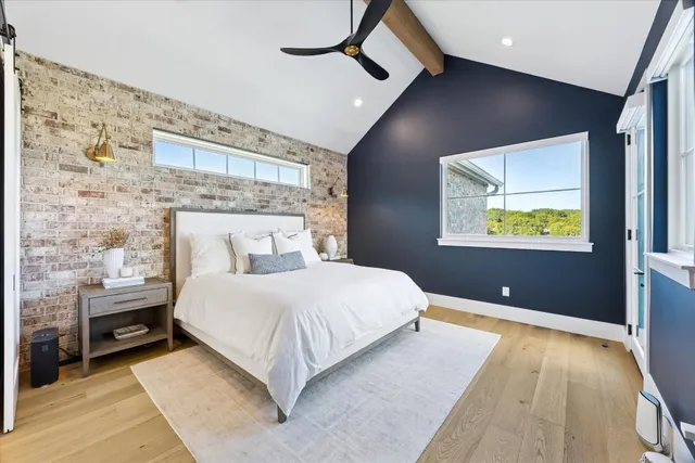 a bedroom with a bed and a painting on the wall