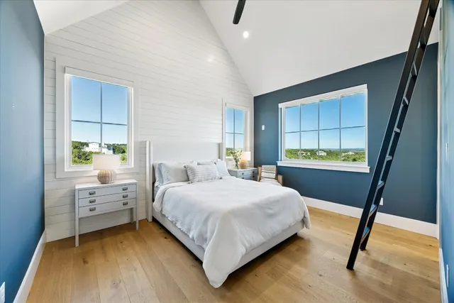 a bedroom with a bed and a large mirror