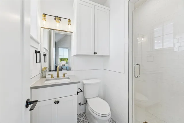 a view of an empty room with a window and hardwood floor