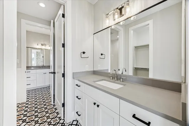 a view of an empty room with wooden floor and windows