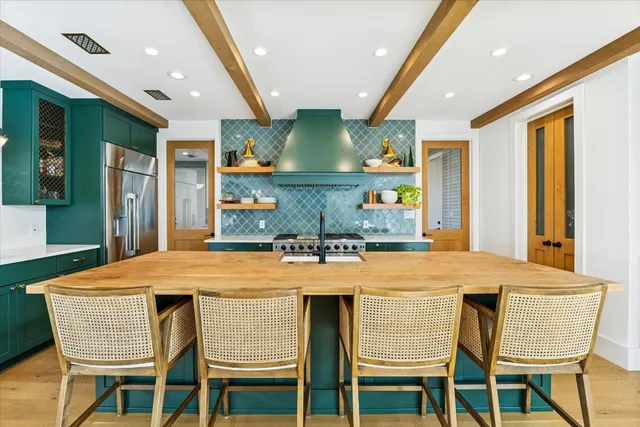 a dining table with chairs and window