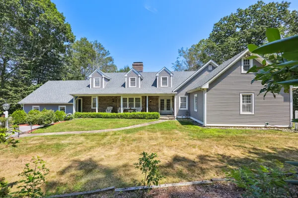 a front view of a house with a garden