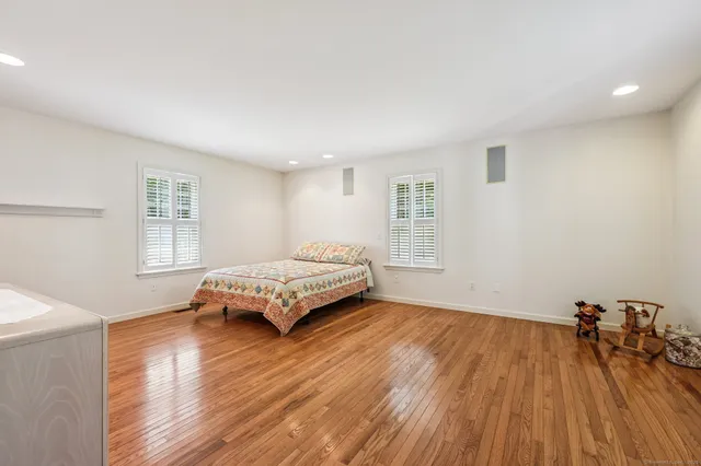 a spacious bathroom with a double vanity sink toilet and shower