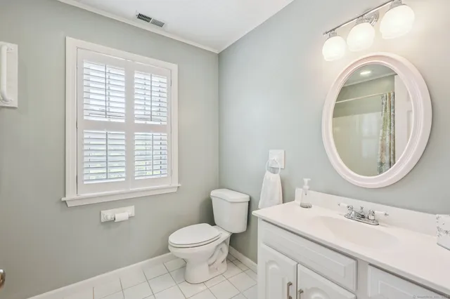 a bathroom with a sink a mirror and a window