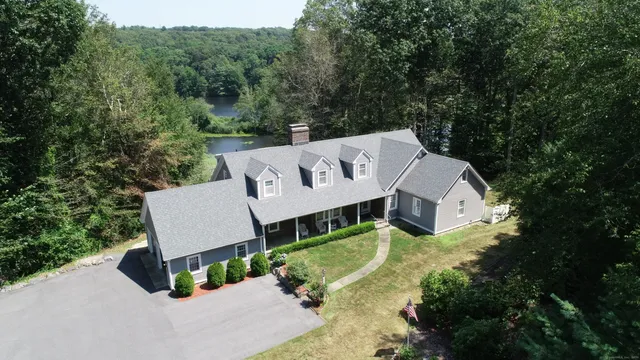 a view of a street with a house in the background