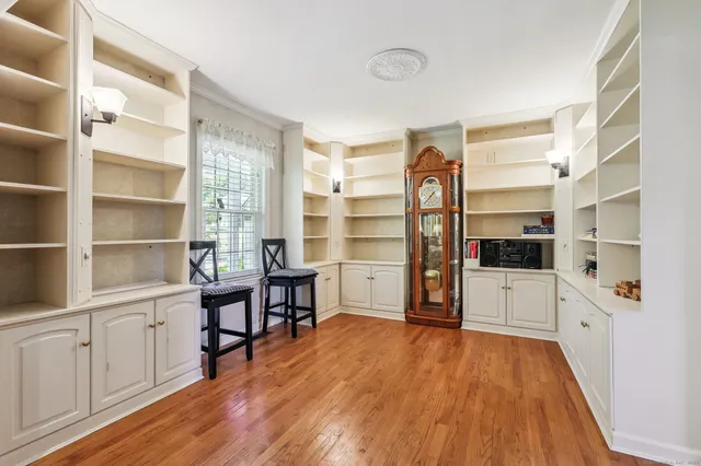 a view of a workspace with furniture and wooden floor