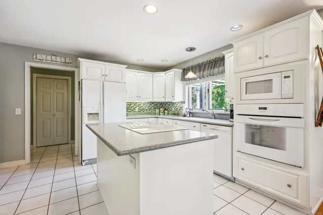 a kitchen with a stove a sink and a refrigerator