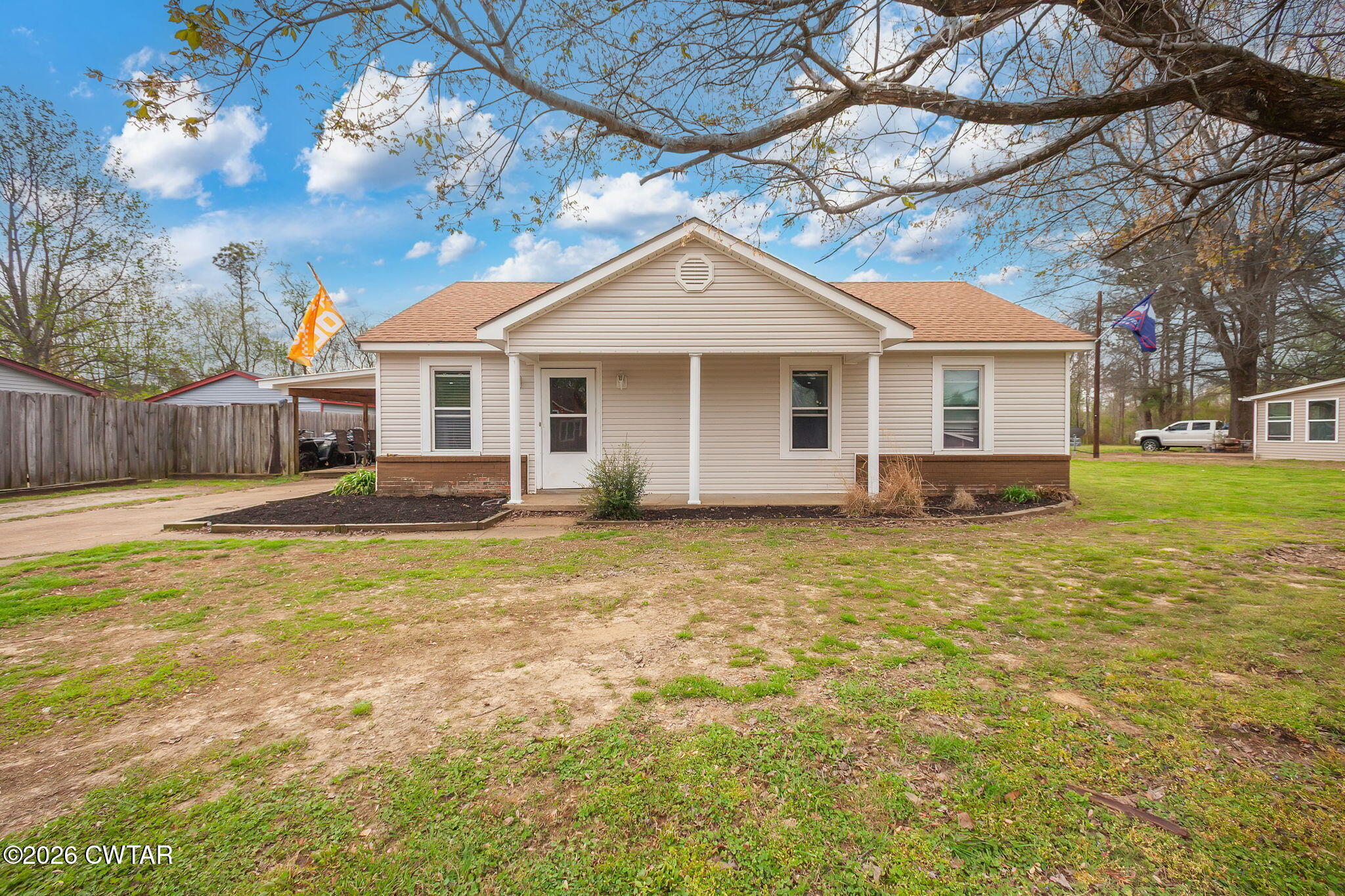 56 Ellendale Place Jackson, TN 38305 - Photo 1 of 23 a front view of house with yard and trees around