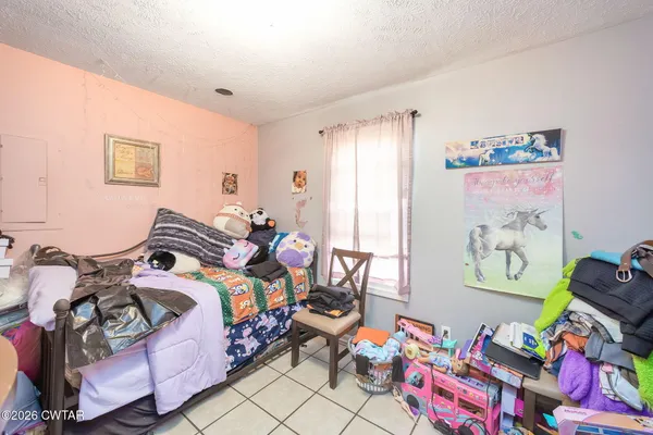 a bedroom with bed and a couch