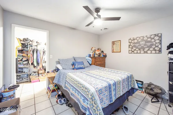 a bedroom with bed and a couch