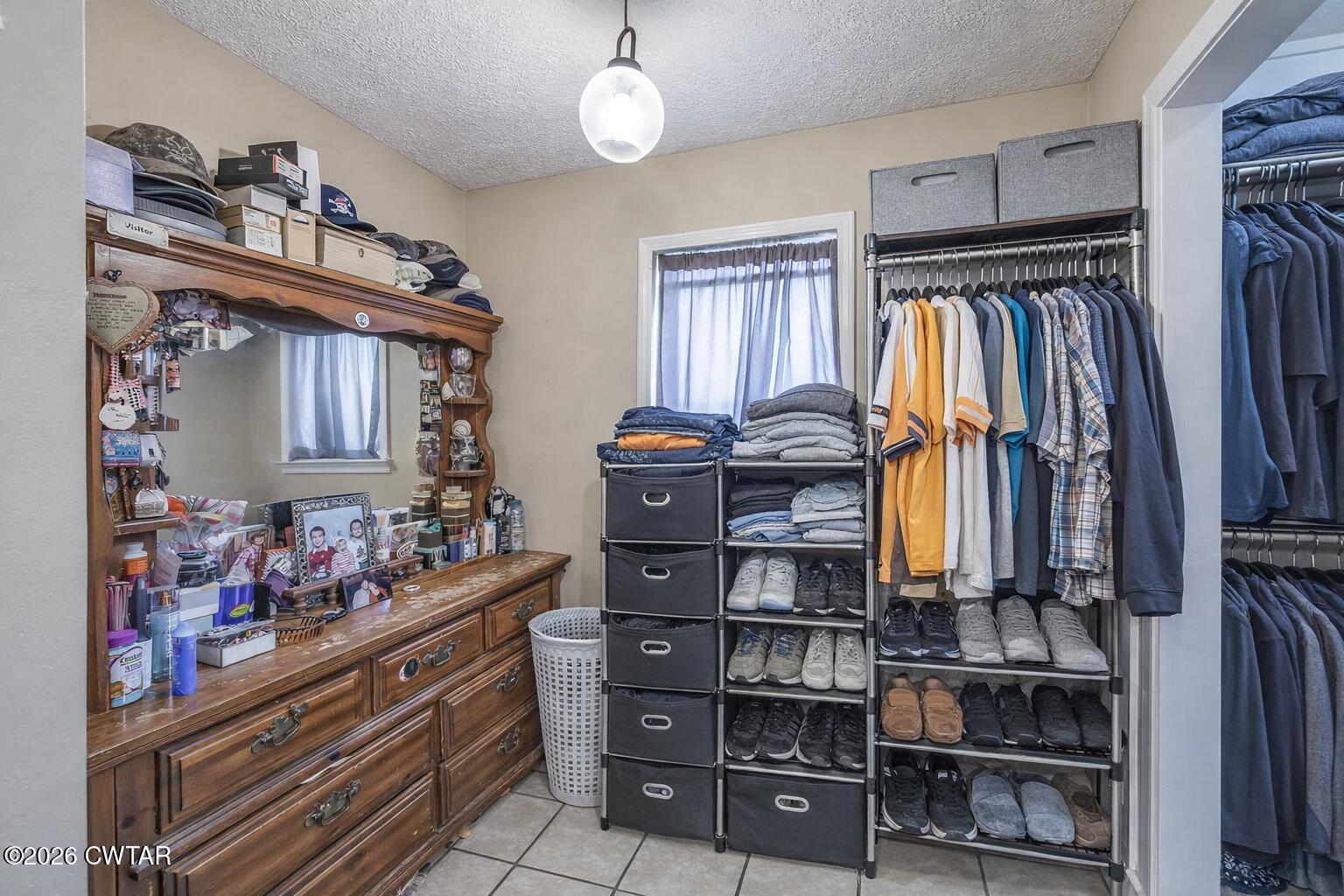 56 Ellendale Place Jackson, TN 38305 - Photo 16 of 23 a view of walk in closet with clothes and shoes