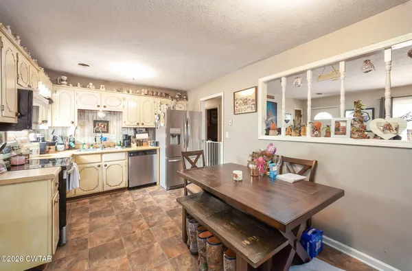 a kitchen with a sink appliances and cabinets