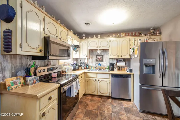 a kitchen with a sink appliances and cabinets