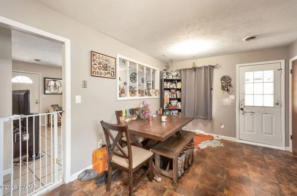 a dining room with furniture and window