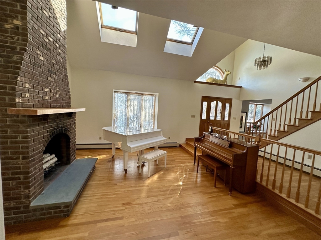 42 Pine Acres Road Foxboro, MA 02035 - Photo 7 of 40 a living room with furniture and a fireplace
