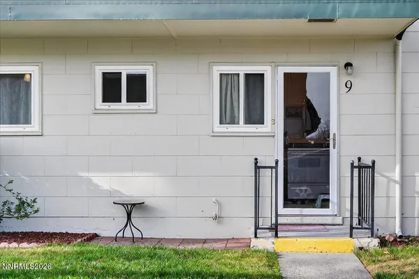 a view of house with backyard and a tub