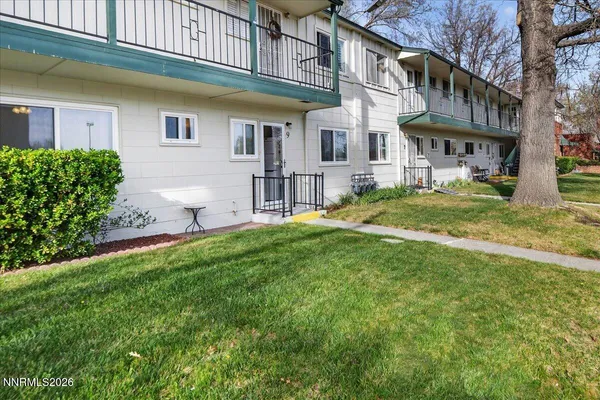 a view of a house with a yard and sitting area