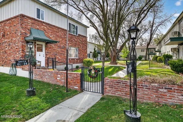 a view of a house with a yard and pathway