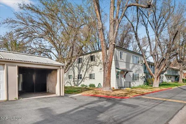 a white house with tree in the background
