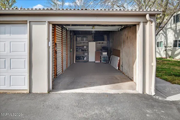 a view of a white house with a yard