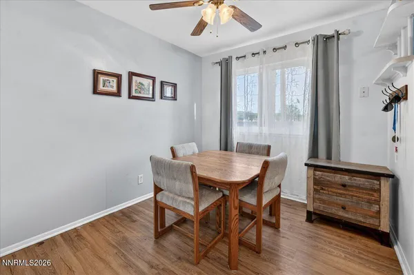 a view of a dining room with furniture window and wooden floor