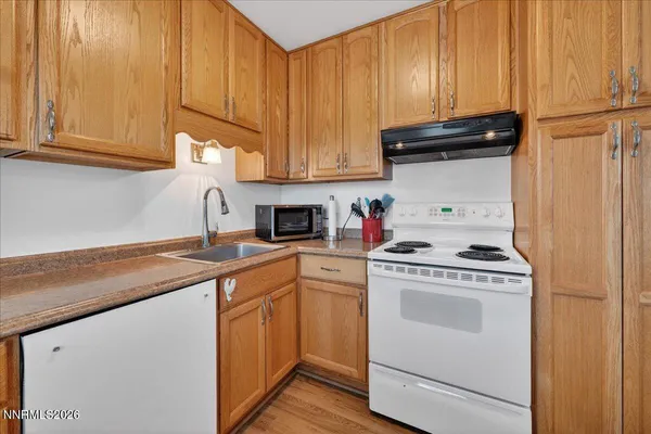 a kitchen with a stove top oven sink and cabinets