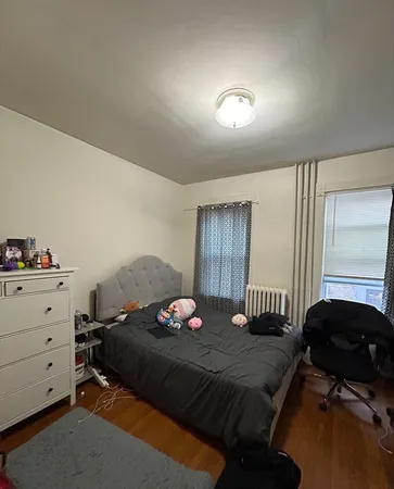 a bedroom with a bed and window