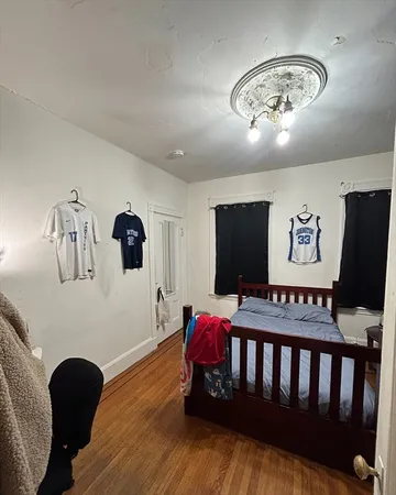 a bedroom with furniture and a chandelier