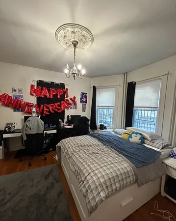 a bedroom with bed and window
