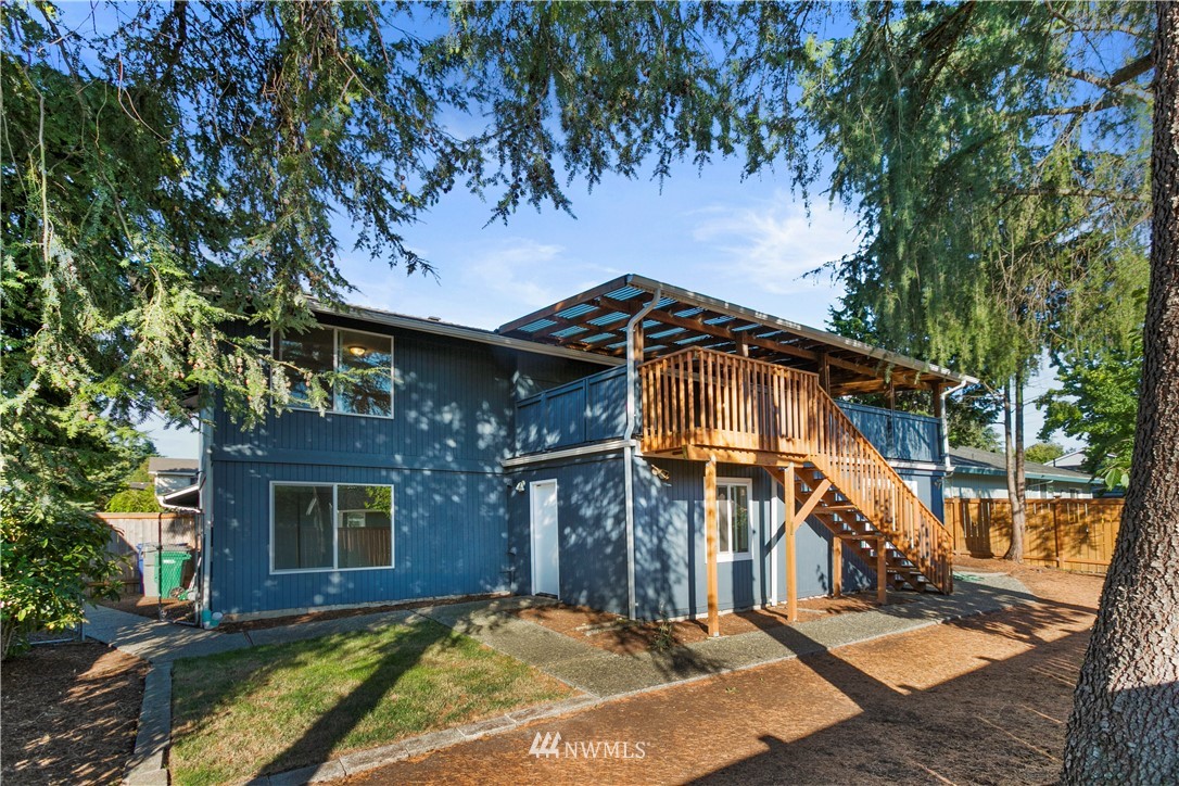 17335 159th Avenue Southeast Renton, WA 98058 - Photo 2 of 35 a view of a brick house with large windows and a small yard