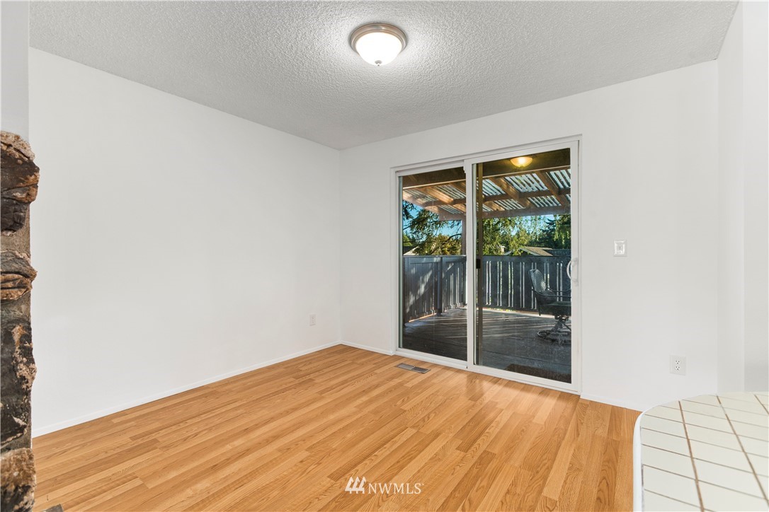 17335 159th Avenue Southeast Renton, WA 98058 - Photo 11 of 35 a view of empty room with wooden floor and fan