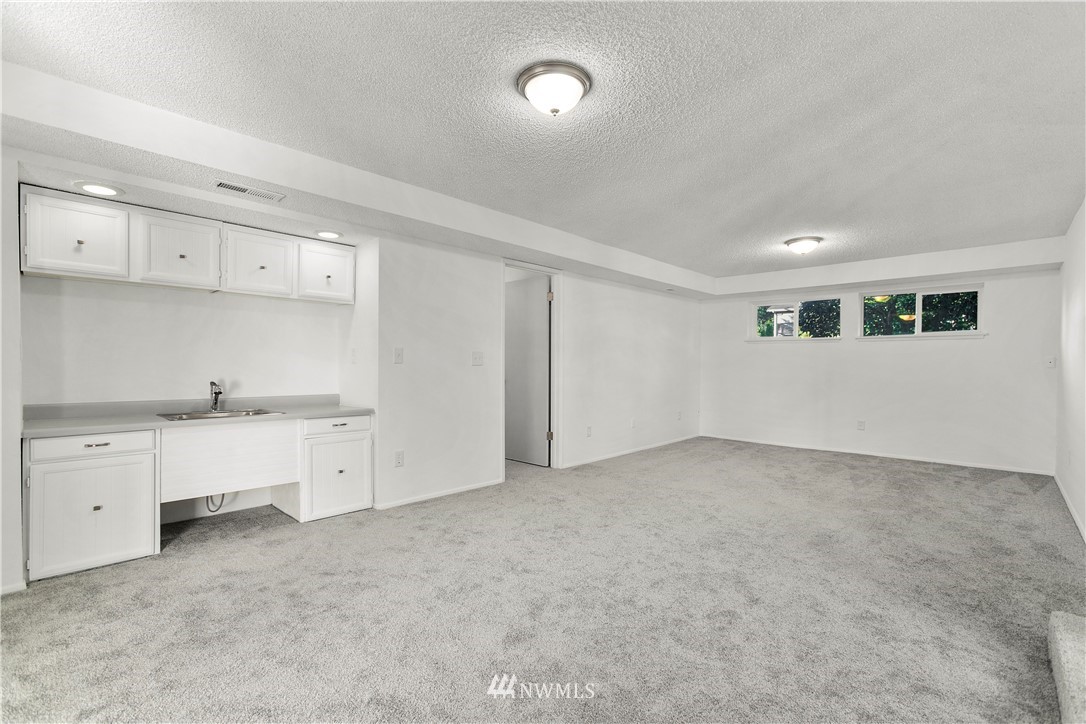 17335 159th Avenue Southeast Renton, WA 98058 - Photo 25 of 35 a view of an empty room with a kitchen