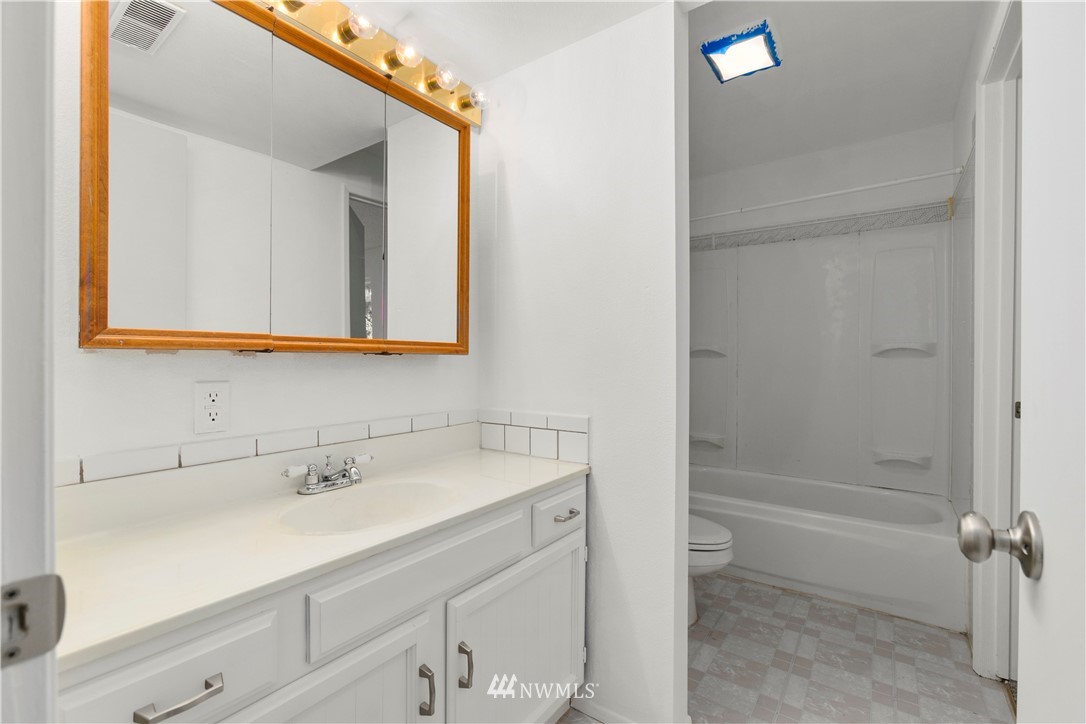 17335 159th Avenue Southeast Renton, WA 98058 - Photo 30 of 35 a bathroom with a sink a toilet and shower