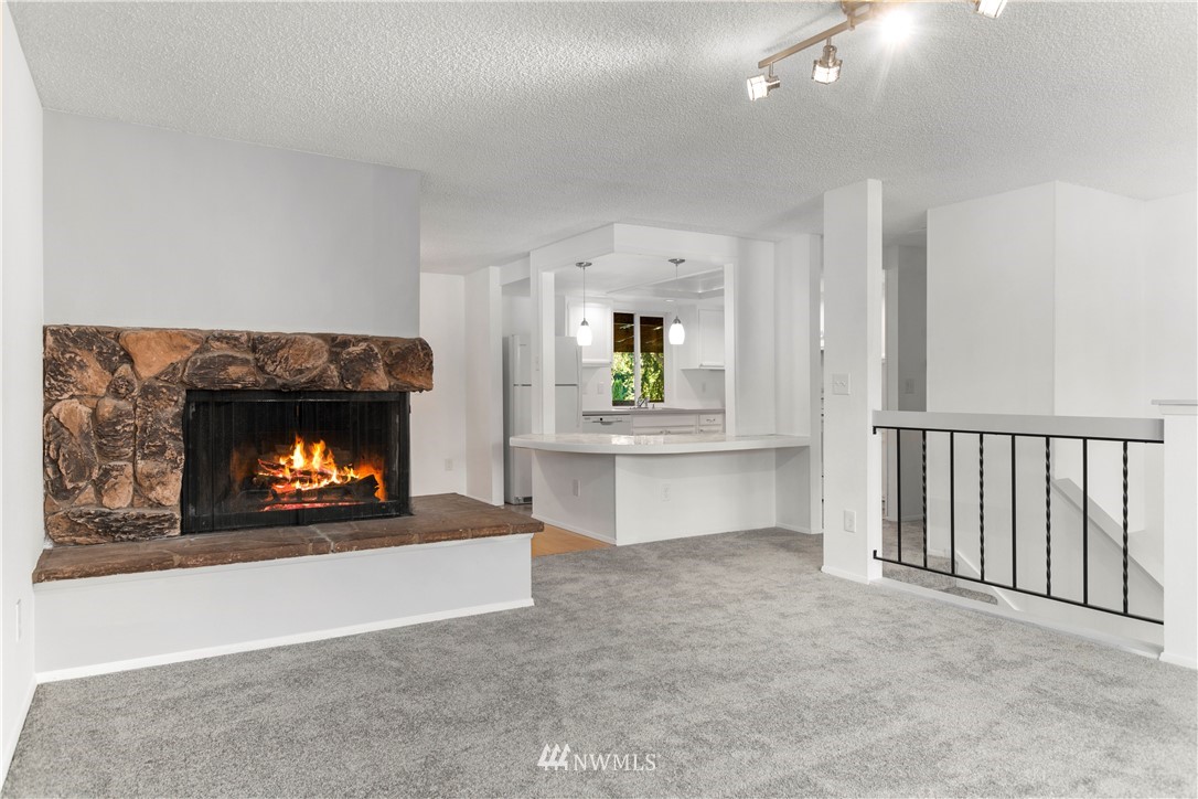 17335 159th Avenue Southeast Renton, WA 98058 - Photo 4 of 35 a living room with furniture and a fireplace