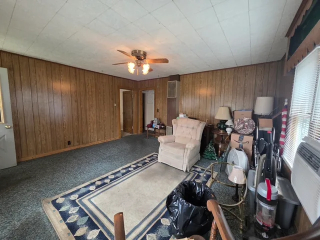 a room with pool table and windows