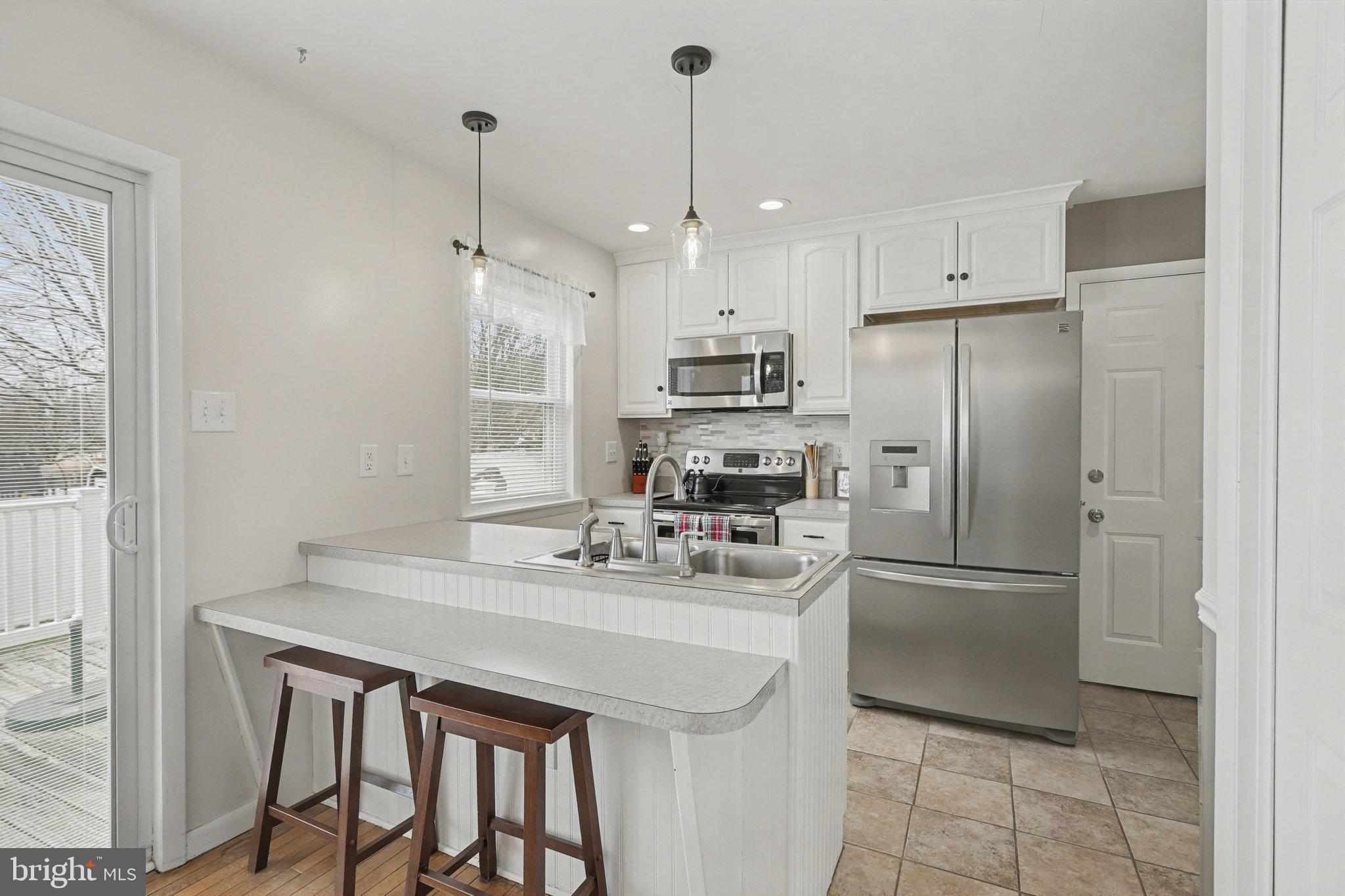 7 Meadow Lane Hanover, PA 17331 - Photo 9 of 31 a kitchen with stainless steel appliances a refrigerator a sink a stove a microwave and island
