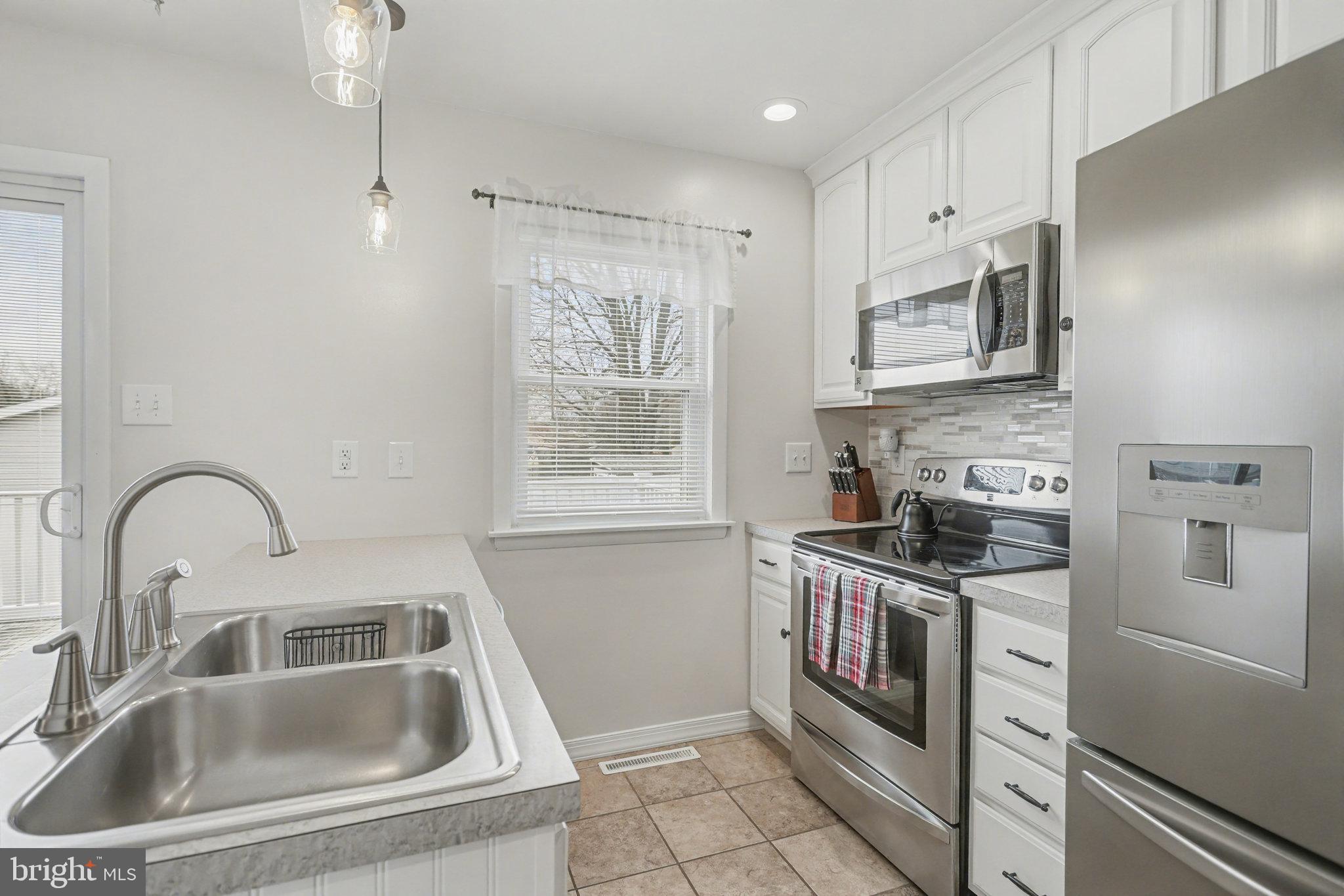 7 Meadow Lane Hanover, PA 17331 - Photo 10 of 31 a kitchen with stainless steel appliances granite countertop a sink stove and cabinets