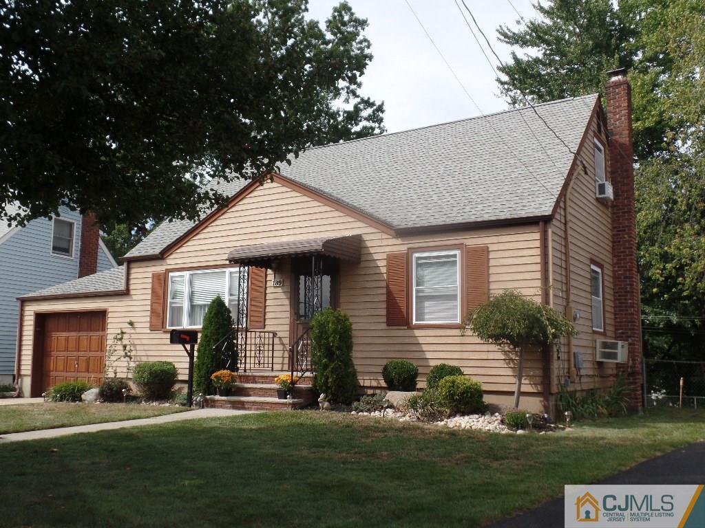 189 Midfield Road Colonia, NJ 07067 - Photo 1 of 16 a front view of a house with a garden and trees
