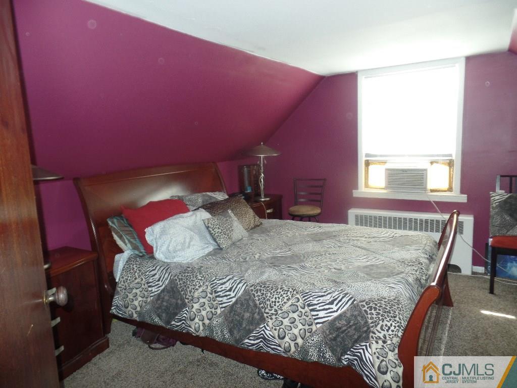 189 Midfield Road Colonia, NJ 07067 - Photo 11 of 16 a bed sitting in a bedroom next to a window