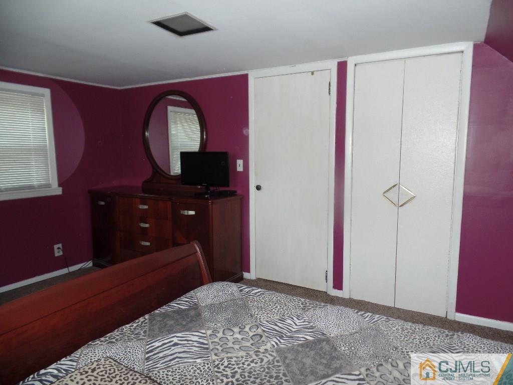 189 Midfield Road Colonia, NJ 07067 - Photo 12 of 16 a bedroom with a bed and a dresser