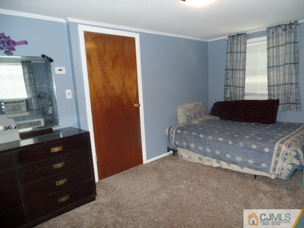189 Midfield Road Colonia, NJ 07067 - Photo 13 of 16 a bedroom with a bed and a dresser