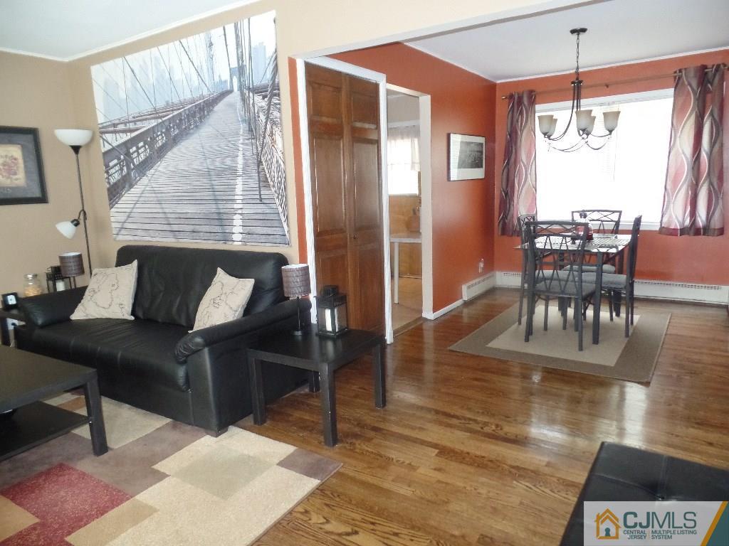 189 Midfield Road Colonia, NJ 07067 - Photo 5 of 16 a living room with furniture a dining table and a chandelier