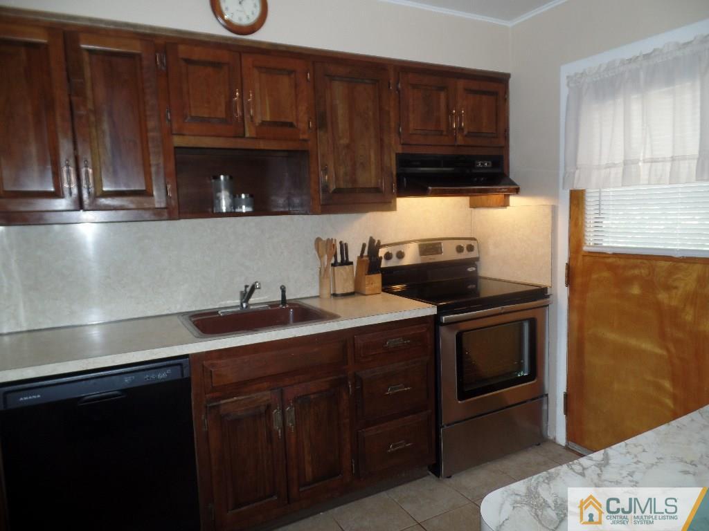 189 Midfield Road Colonia, NJ 07067 - Photo 6 of 16 a kitchen with granite countertop a sink cabinets and stainless steel appliances