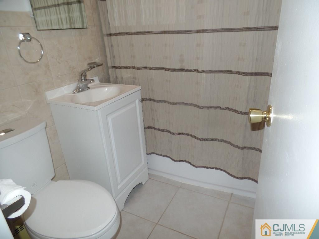 189 Midfield Road Colonia, NJ 07067 - Photo 8 of 16 a bathroom with a sink a toilet and shower