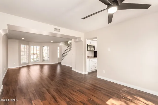 a kitchen with granite countertop a refrigerator stove top oven and sink